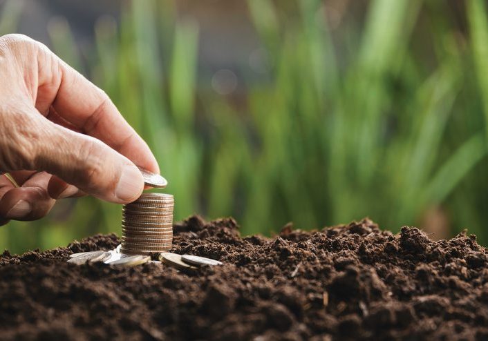 Hand with money coins stack, Business investment growth concept, saving concept, Hand putting stack of coin.